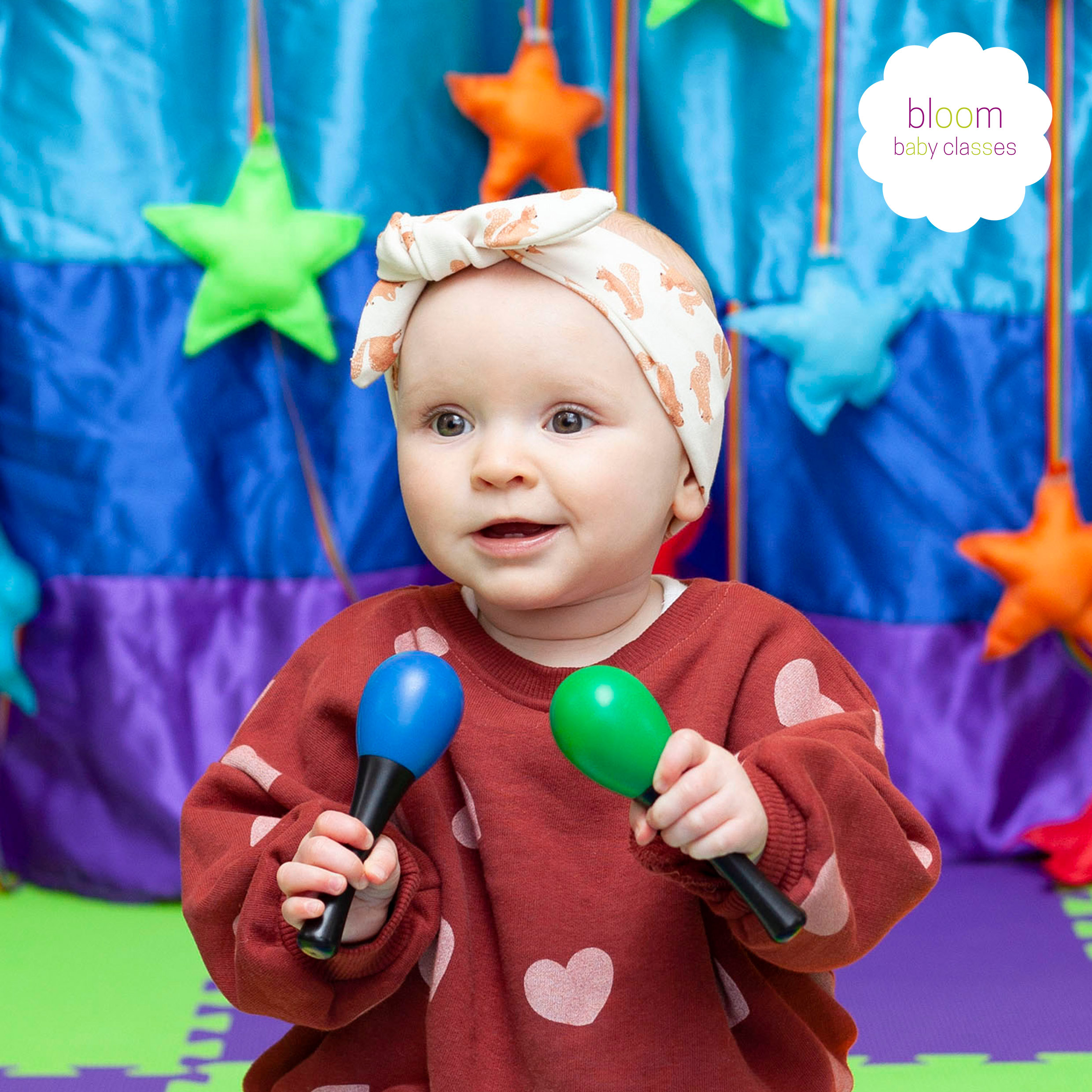 baby shaking maraccas at bloom baby week